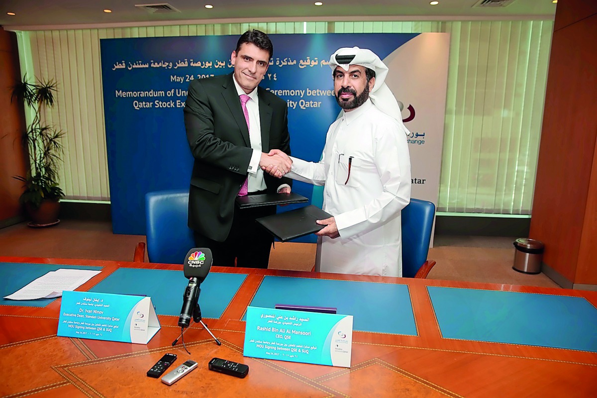 Qatar Stock Exchange CEO, Rashid bin Ali Al Mansoori (right) and Dr Ivan Ninov, Executive Dean of SUQ, after the signing ceremony.