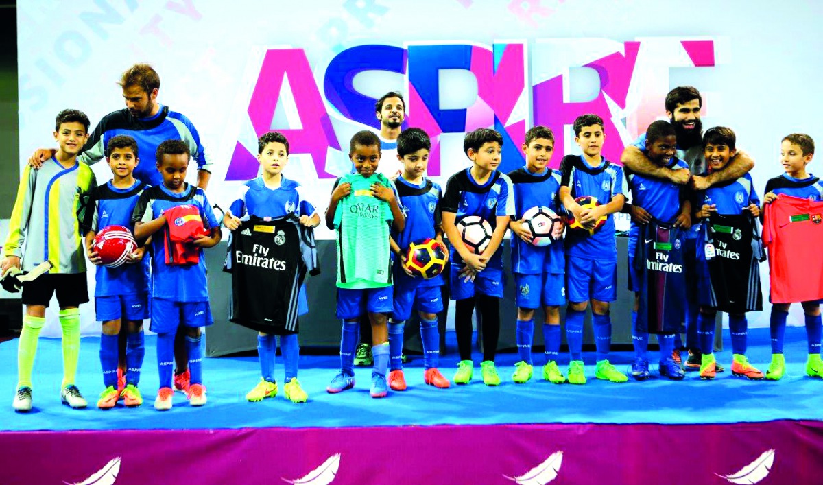 Future football stars who are part of the Feeder Group programme at Aspire Academy Football Department pose for a photograph with officials during the closing ceremony of the 2016/2017 football season on Thursday.
