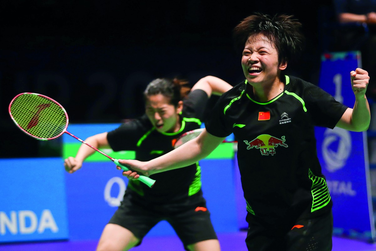Chen Qingchen (right) and Jia Yifan of China celebrate their victory in the women's doubles Sudirman Cup match against Misaki Matsutomo and Ayaka Takahashi of Japan at the Gold Coast Sports Centre, yesterday.