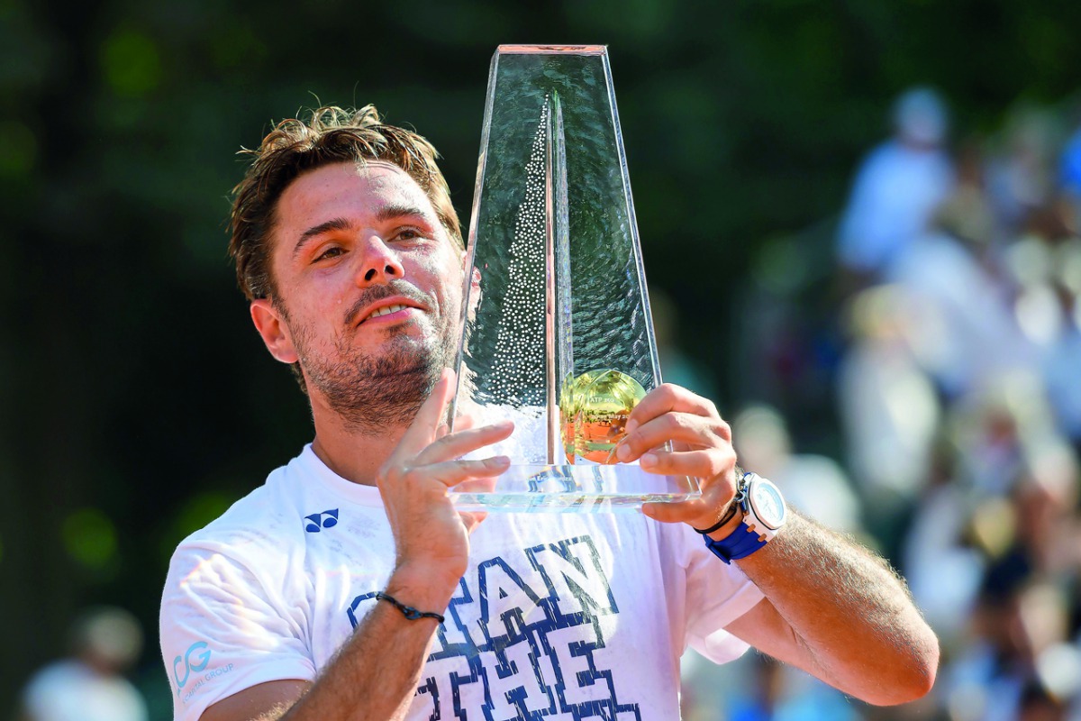 Stan Wawrinka  of Switzerland raises the trophy after winning the Geneva Open ATP 250 Tennis tournament, in Geneva, yesterday.
