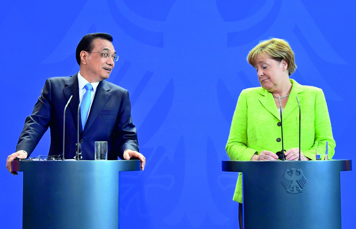German Chancellor Angela Merkel (right) and Chinese Prime Minister Li Keqiang give a joint press conference after representatives of both countries signed economic agreements at the end of Li's two-day visit to Germany. Chancellor Merkel also addressed th