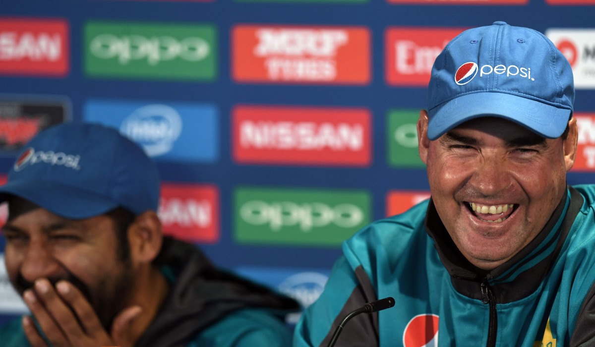 Pakistan coach Mickey Arthur (R) and captain Sarfraz Ahmed share a light moment during a press conference at Edgbaston cricket ground in Birmingham on June 3, 2017, ahead of the ICC Champions Trophy cricket match between Pakistan and India. (AFP / Paul EL