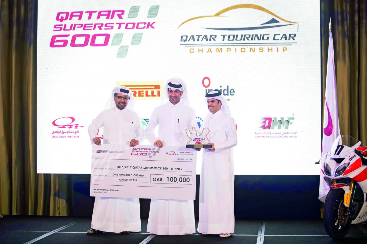 Saeed Al Sulaiti receiving winner's cheque of QR 100,000 from QMMF President Abdulrahman Al Mannai and LCSC Vice- President and General Manager Khalid Al Remaihi at Ritz Carlton yesterday.