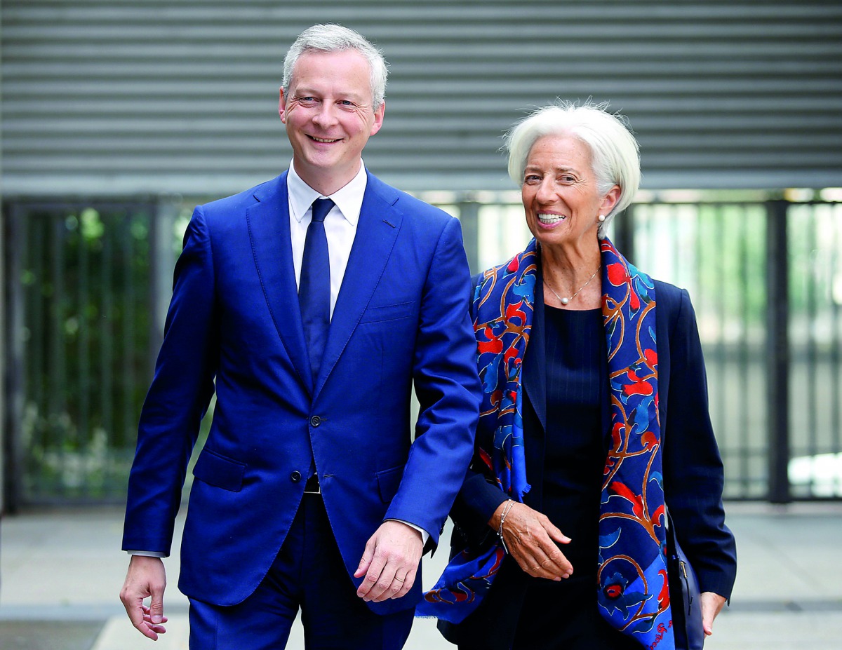 French Economy Minister Bruno Le Maire (left) greets Christine Lagarde, head of the International Monetary Fund (IMF), upon her arrival at the Bercy Finance Ministry in Paris, France, yesterday.