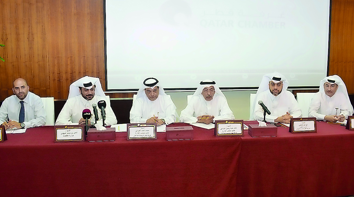 Nasser bin Mohammed Al Mohannadi (left), representative of the Ministry of Economy and Commerce; Mohamed Ahmed Al Obaidly of QC, and other officials at the traders meeting at QC headquarters, yesterday.
