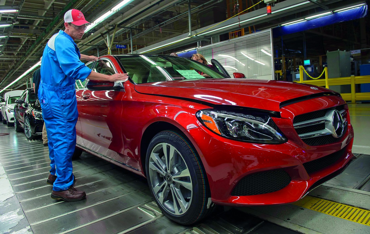 An employee does final inspections on a Mercedes-Benz C-Class at the Mercedes-Benz US International factory in Vance, Alabama. US President Donald Trump's harsh criticism of Germany's trade practices is sowing concerns in rural, Republican Alabama, where 
