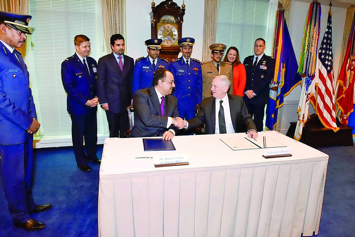 Minister of State for Defence Affairs H E Dr Khalid bin Mohammed Al Attiyah shaking hands with US Secretary of Defence James Mattis after signing an agreement for the purchase of F-15 fighter jets, with an initial cost of $12bn, in Washington, yesterday.