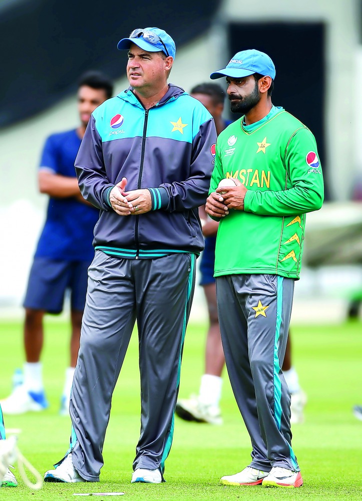 Pakistan's Mohammad Hafeez talks with head coach Mickey Arthur during nets.