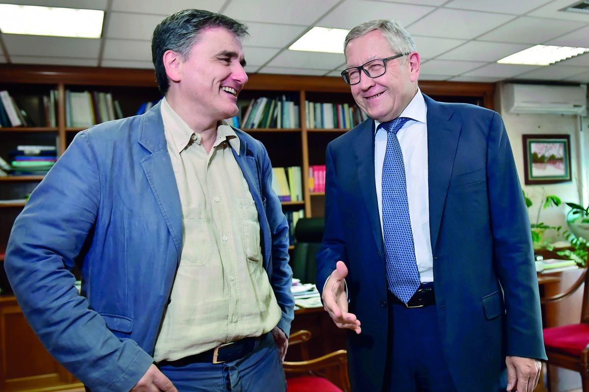 Greek's Finance Minister Euclid Tsakalotos (left) speaks with Managing Director of the European Stability Mechanism , Klaus Regling, in his office in Athens, yesterday.