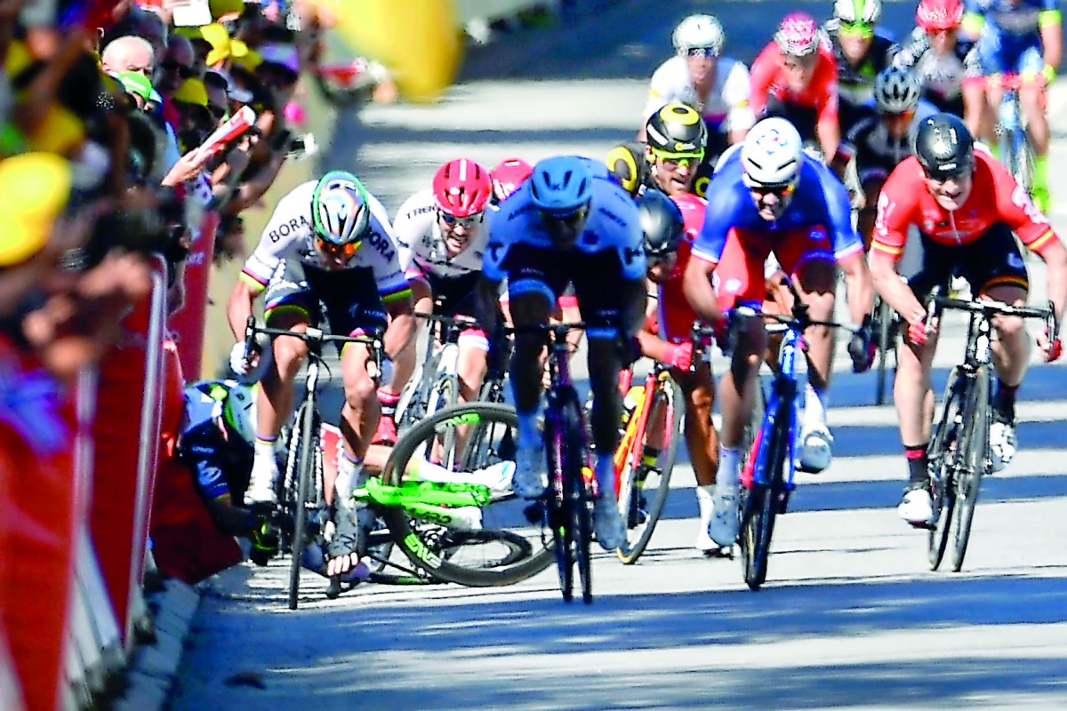 Great Britain's Mark Cavendish (left) falls near the finish line at the end of the fourth stage of the 104th edition of the Tour de France cycling race on Tuesday between Mondorf-les-Bains and Vittel. Tour de France jury yesterday kicked world champion Pe
