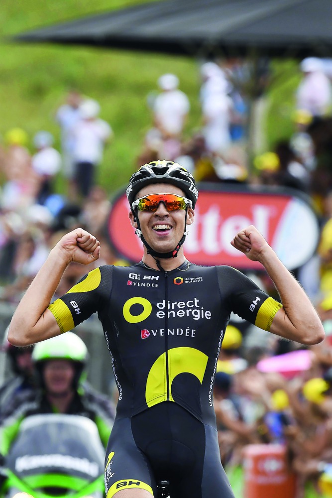 France's Lilian Calmejane celebrates as he crosses the finish line at the end of eighth stage of Tour de France.