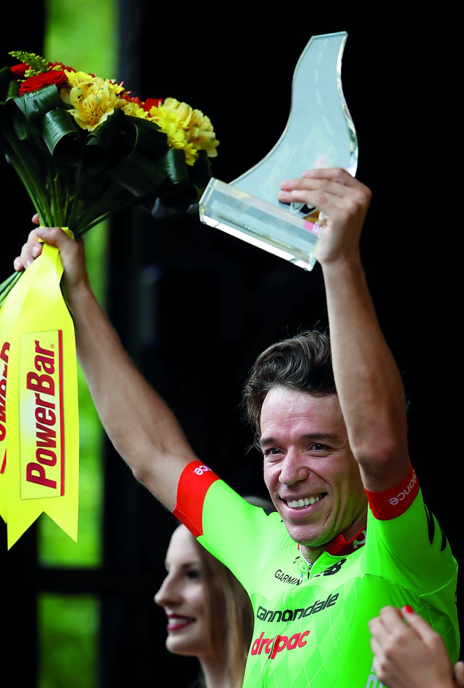 Cannondale-Drapac rider Rigoberto Uran of Columbia celebrates his stage win on the podium.