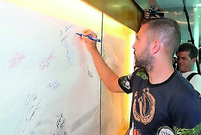 Barcelona's Spanish  defender Jordi Alba  signs on the wall of celebrities at the Aspire Academy during his recent visit to Doha.