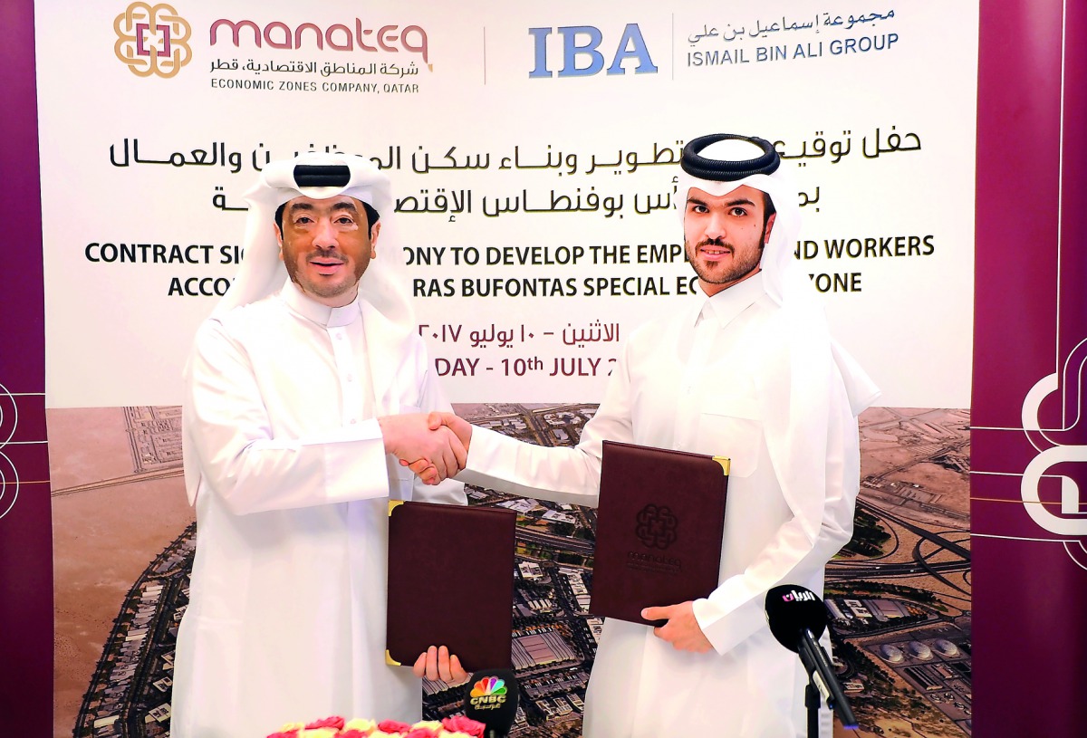 Fahad Rashid Al Kaabi, CEO of Manateq (left), shaking hands with Hamad Mohammed Esmael Al Emadi, CEO of Ismail Bin Ali Group, at the signing ceremony in Doha, yesterday.  Pic: Abdul Basit/The Peninsula 