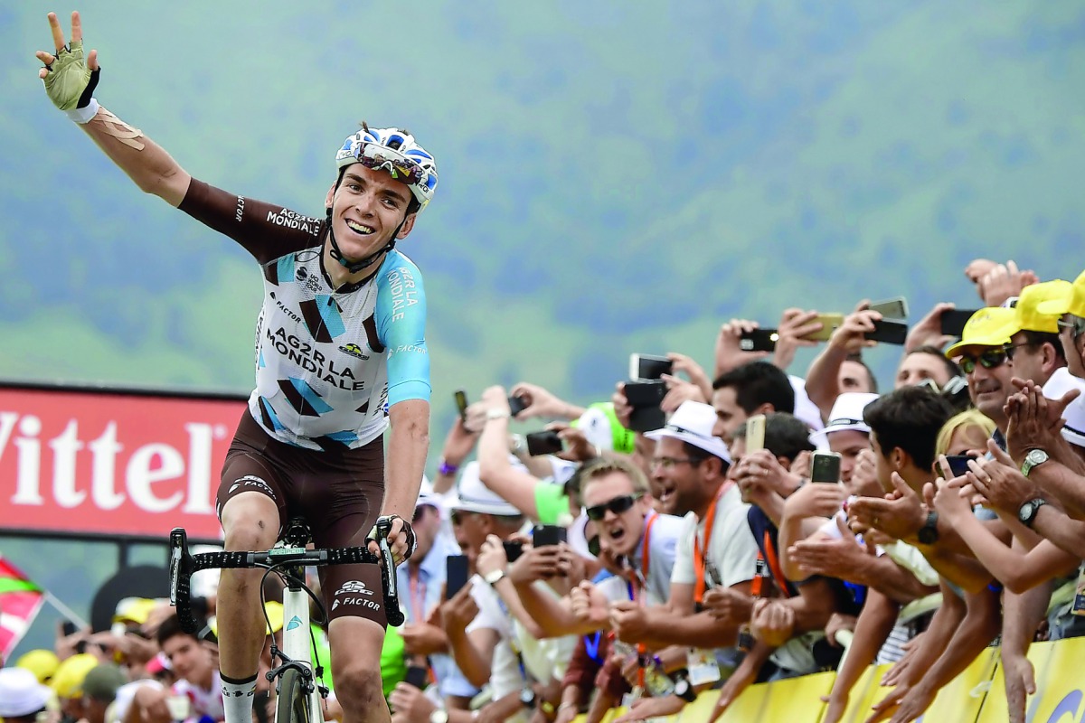 French rider Romain Bardet celebrates as he crosses the finish line at the end of the 214,5 km 12th stage of the 104th Tour de France. 