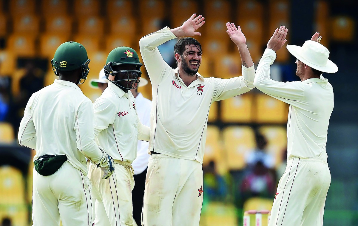 Zimbabwe’s captain Graeme Cremer (second right) celebrates with his team-mates after he dismissed Sri Lanka’s Niroshan Dickwella during the Second day of their one-off Test match at the R Premadasa Cricket Stadium in Colombo, yesterday. 