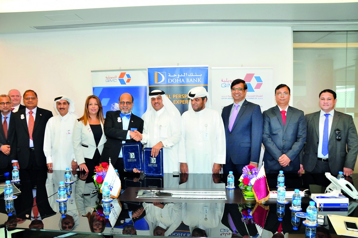 Abdul Rahman A Al Ansari, CEO of QIMC, shaking hands with Dr R Seetharaman, CEO of Doha Bank, after the signing ceremony. 