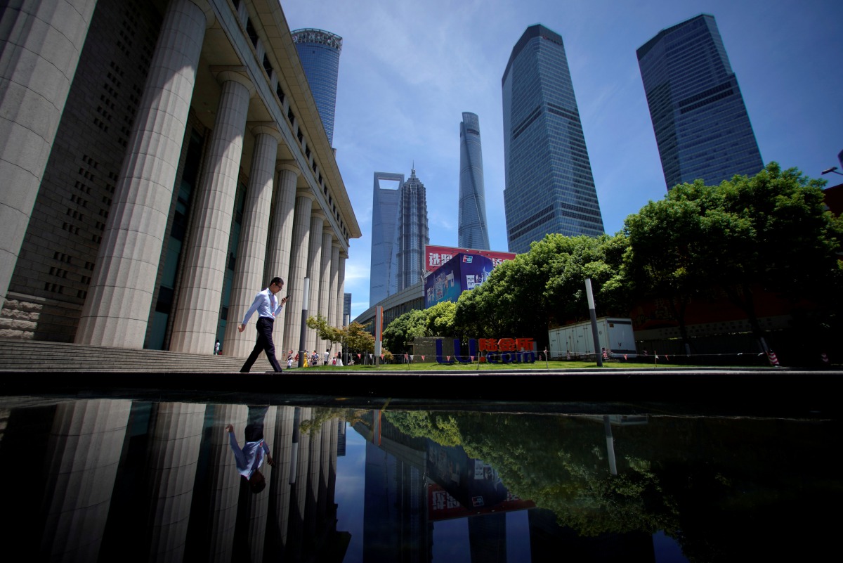 A man walks at Lujiazui financial district of Pudong in Shanghai, China July 17, 2017. (REUTERS/Aly Song)