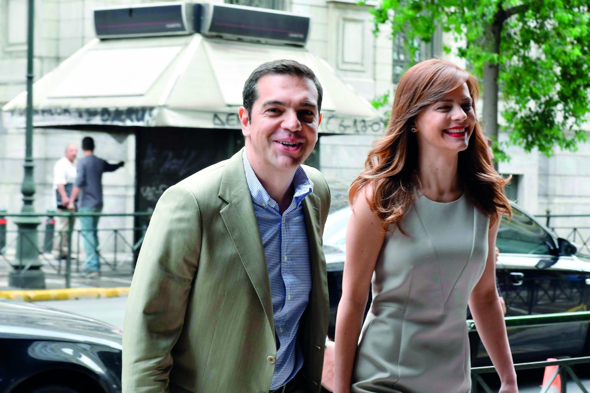 Greek Prime Minister Alexis Tsipras (left)  arrives for his meeting with Labour Minister Efi Achtsioglou in central Athens, yesterday. Bolstered by its third bailout programme and positive reports from the European Union, Greece is planning an imminent te