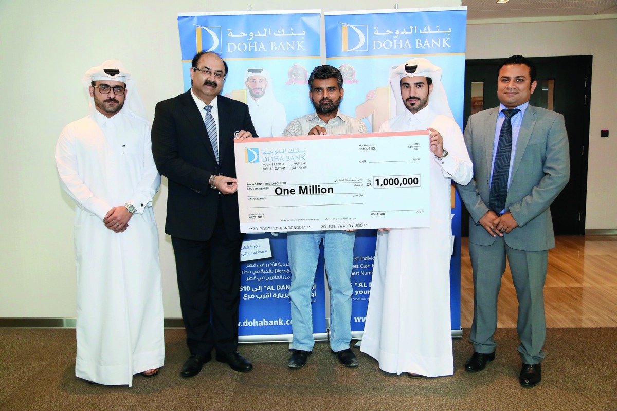 The winners of Doha Bank’s Al Dana savings scheme posing with the QR1m mega prize cheque with senior officials of the Bank. 
