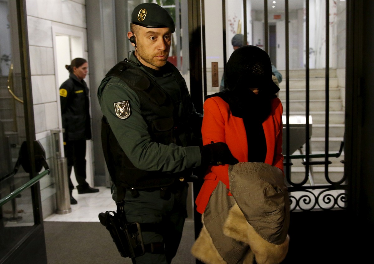 A suspect identified by bank employees as Wang Jing is led by a Spanish Civil Guard officer as they leave the headquarters of Industrial and Commercial Bank of China (ICBC) during a raid in Madrid, Spain, February 17, 2016. To match Special Report ICBC-SP