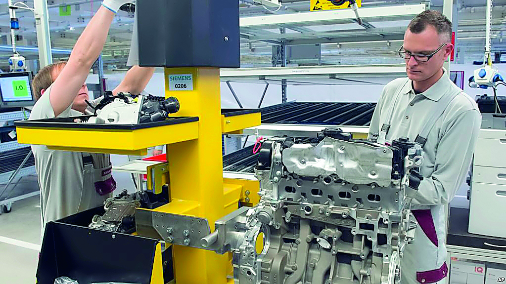 An employee works on a new diesel engine in this file picture at a company in Germany.