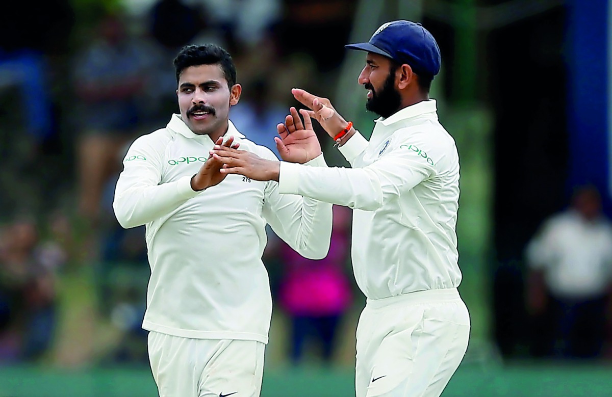 India’s Ravindra Jadeja celebrates with his team-mate Cheteshwar Pujara after taking the wicket of Sri Lanka’s Dhananjaya de Silva (not pictured).