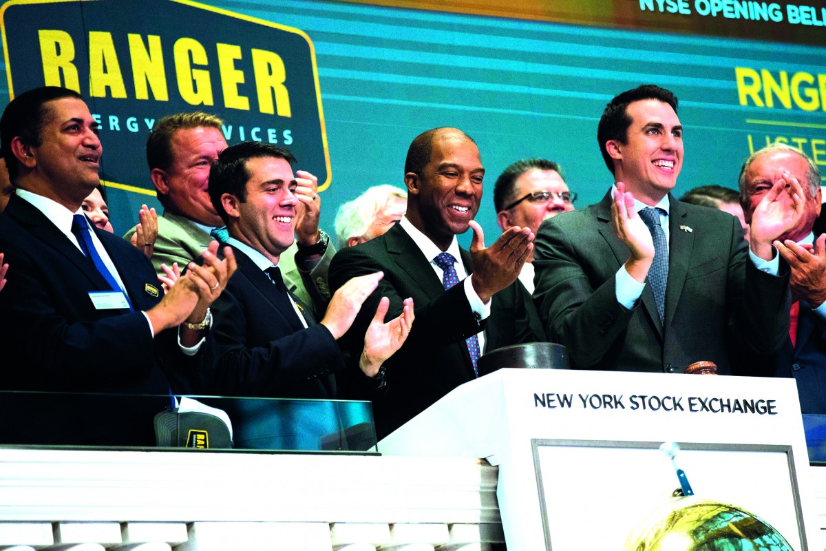 arron M. Anderson (C), president and chief executive officer of Ranger Energy Services, applauds after ringing the opening bell to celebrate his company's initial public offering (IPO) at the New York Stock Exchange (NYSE), August 11, 2017 in New York Cit