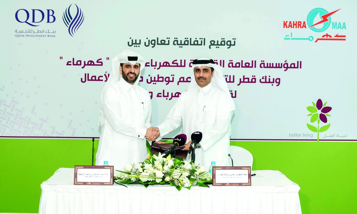 Abdulaziz bin Nasser Al Khalifa (left), CEO, QDB, and Essa bin Hilal Al Kuwari, President, Kahramaa, shaking hands after signing the agreement, yesterday.
