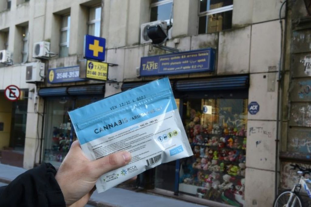 (File Photo) A man holds an envelope of marijuana that he purchased at a pharmacy in Montevideo in this file photo from July 19
