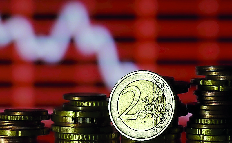 Euro coins are seen in front of a displayed stock graph in Zenica, Bosnia and Herzegovina.