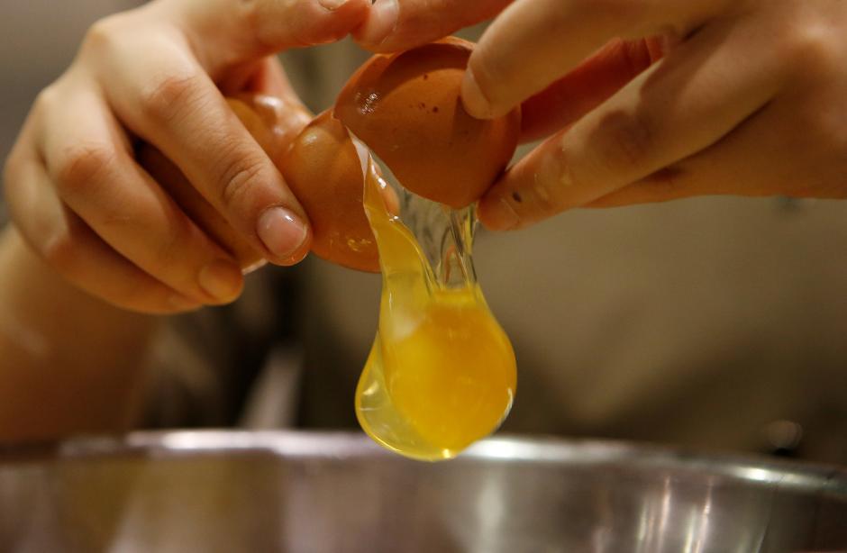 A pastry chef breaks an egg as she prepares to bake a cake at a bakery in Seoul, South Korea, December 22, 2016 (Reuters / Kim Hong-Ji) 
