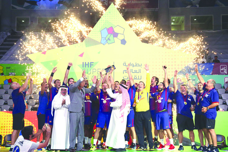 FC Barcelona Lassa players and officials celebrate with the IHF Super Globe Championship trophy after defeating Germany’s Fuchse Berlin in the final played at Duhail Sports Complex on Monday.