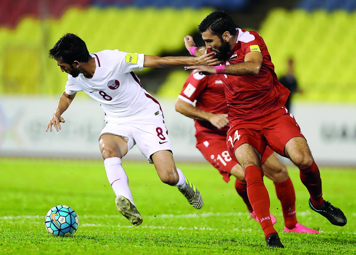 Qatar’s Ali Assadalla (left) vies for the ball possession against Syria’s Zaher Al Medani and Tamer Hag Mohamad (right) during their Group A 2018 World Cup qualifier played at Hang Jebat Stadium in Melaka, Malaysia yesterday. Syria notched up a 3-1 win to