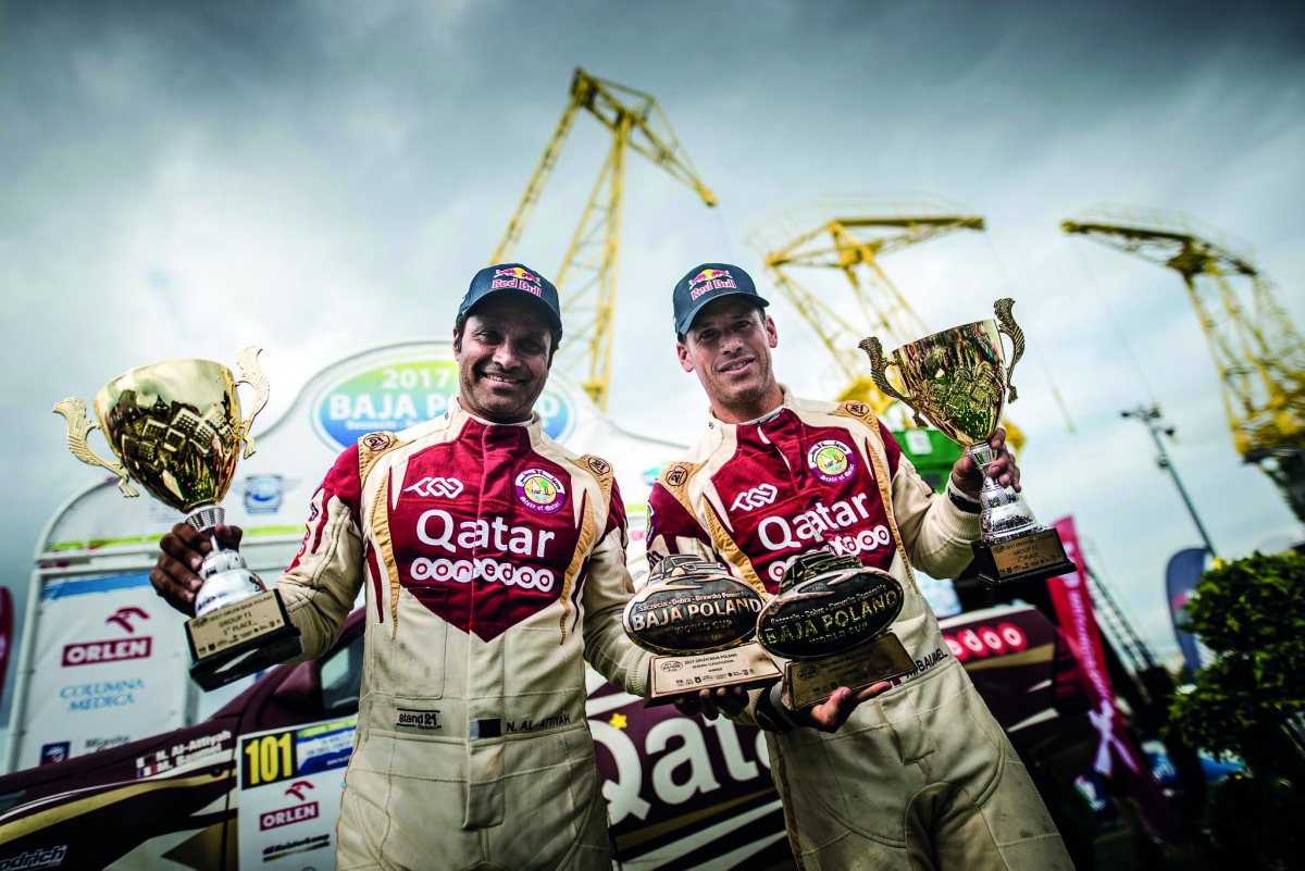 Qatar’s Al Attiyah and French navigator Matthieu Baumel celebrate after winning the ORLEN Baja in Szczecin, Poland yesterday.