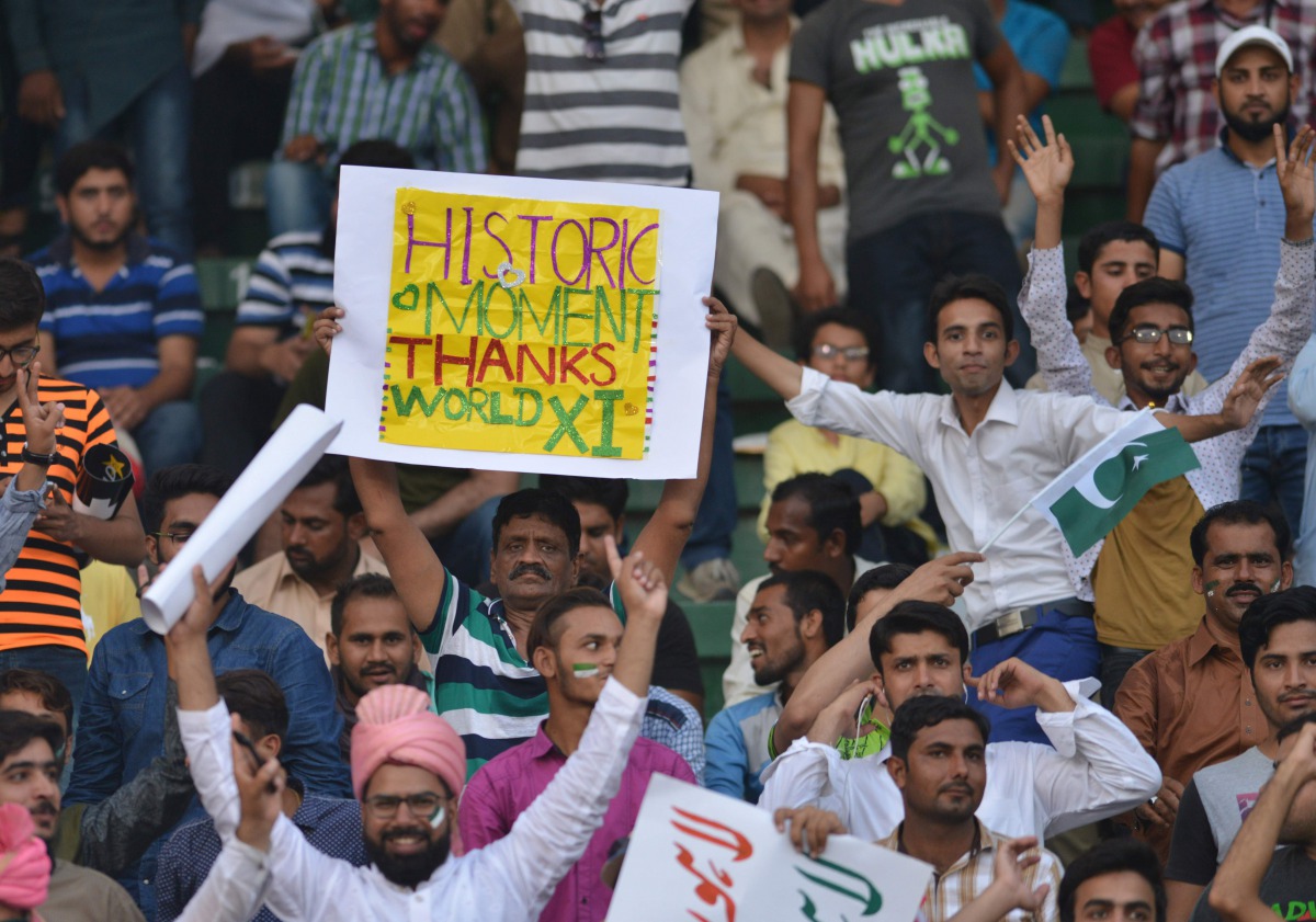Pakistani spectators cheer at the start of the first Twenty20 international match between the World XI and Pakistan at the Gaddafi Cricket Stadium in Lahore on September 12, 2017. The World XI play their first Twenty20 international match against Pakistan