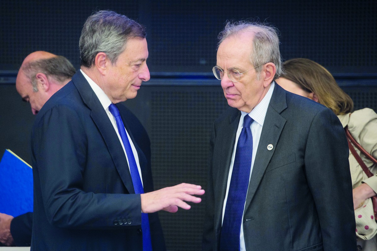 Italy’s Finance Minister Pietro Carlo Padoan (right) and President of the European Central Bank Mario Draghi chat during an informal meeting of the Eurozone economic and financial affairs ministers (ECOFIN) in Tallinn, Estonia, yesterday. ECB President Ma