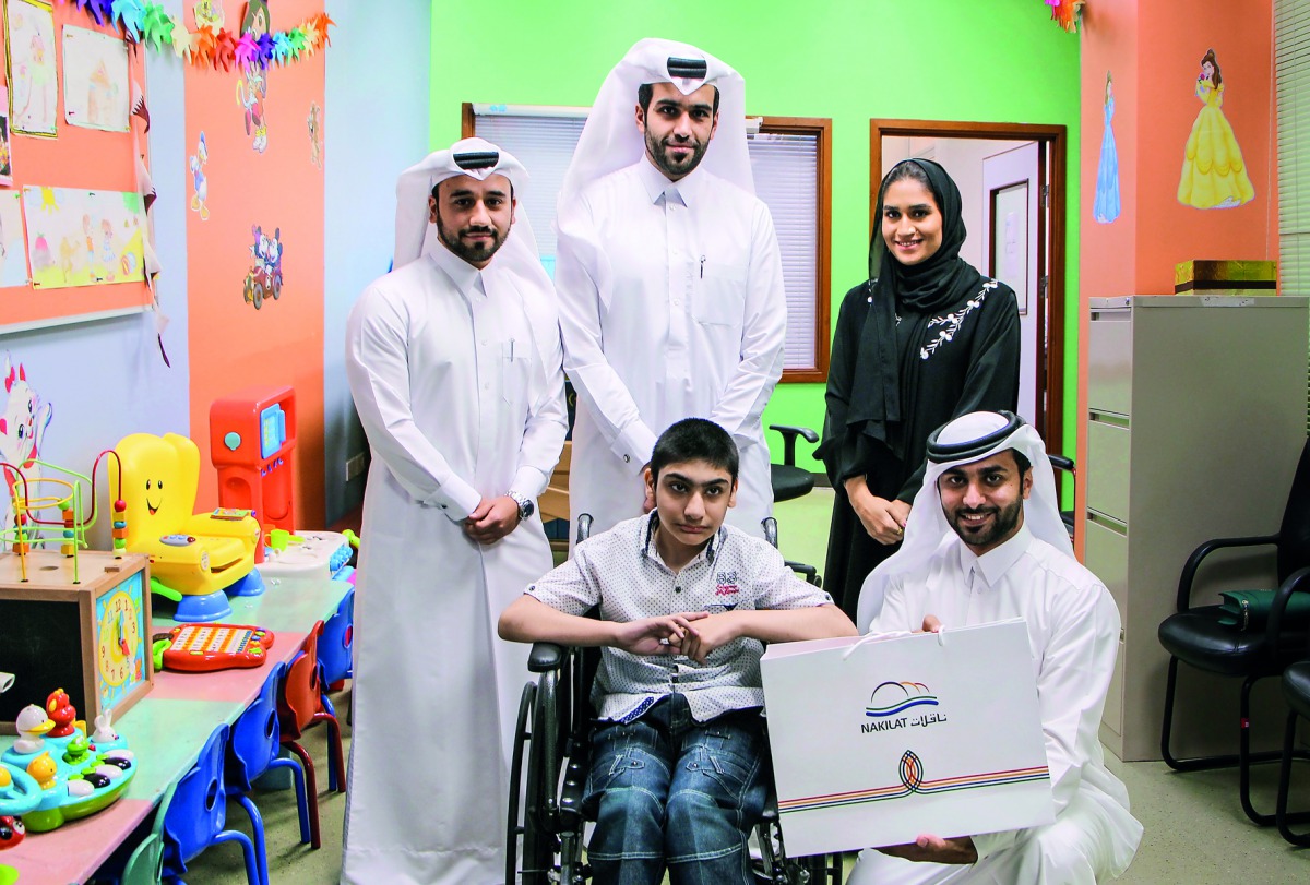 Officials of Nakilat give gifts to children at HGH. 