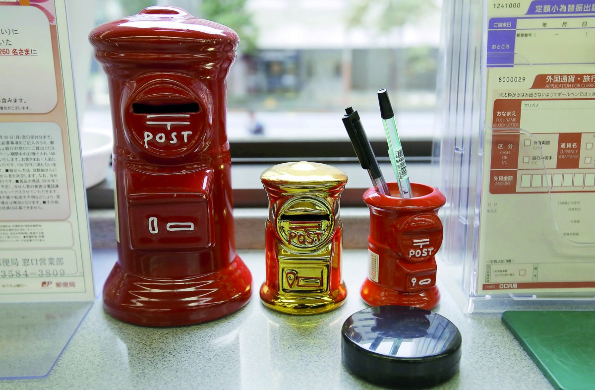 ost box shaped piggy banks (L and C) and a penholder are seen at a post office of Japan Post Co in Tokyo, Japan, November 2, 2015. REUTERS/Toru Hanai
