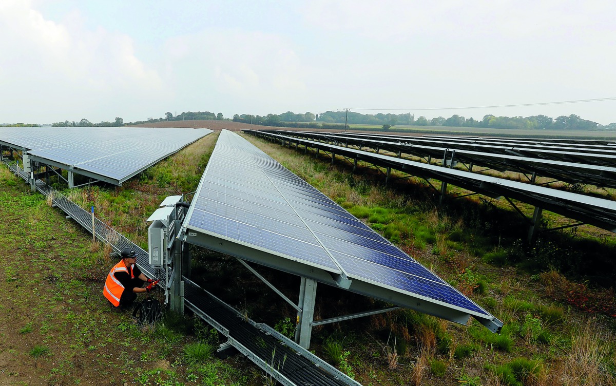 Anesco engineer Tommy Good works on Clayhill Solar Power Farm, Britain’s first to operate without a government subsidy in Westoning, Britain, yesterday. Anesco is UK’s leading energy efficiency solution company.