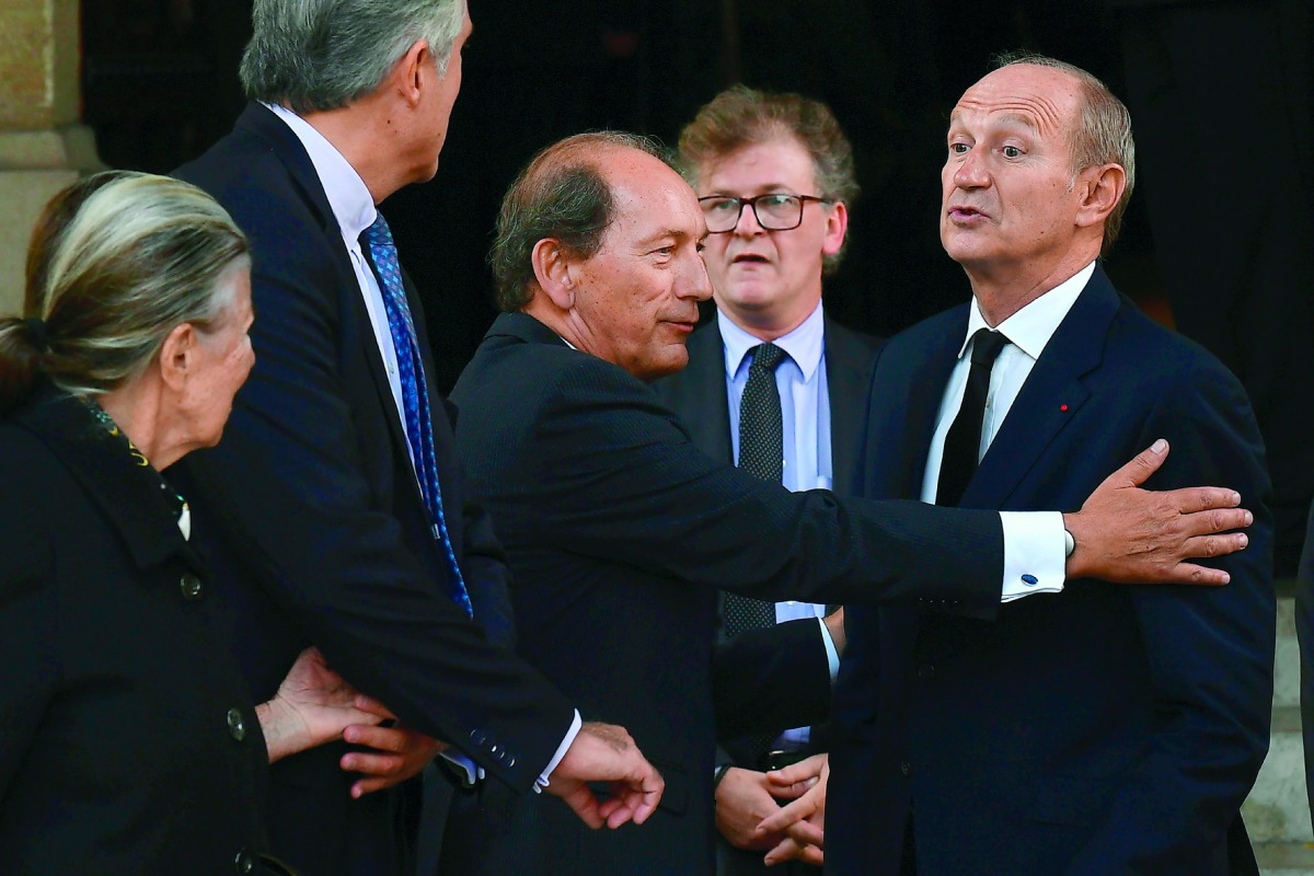 Nestle CEO Paul Bulcke (3rdL) talks with L'Oreal Chairman Jean-Paul Agon (R) as they leave after attending the funeral of L'Oreal heiress, Liliane Bettencourt, on September 26, 2017 at the Saint-Pierre church in Neuilly-sur-Seine, near Paris. Bettencourt,
