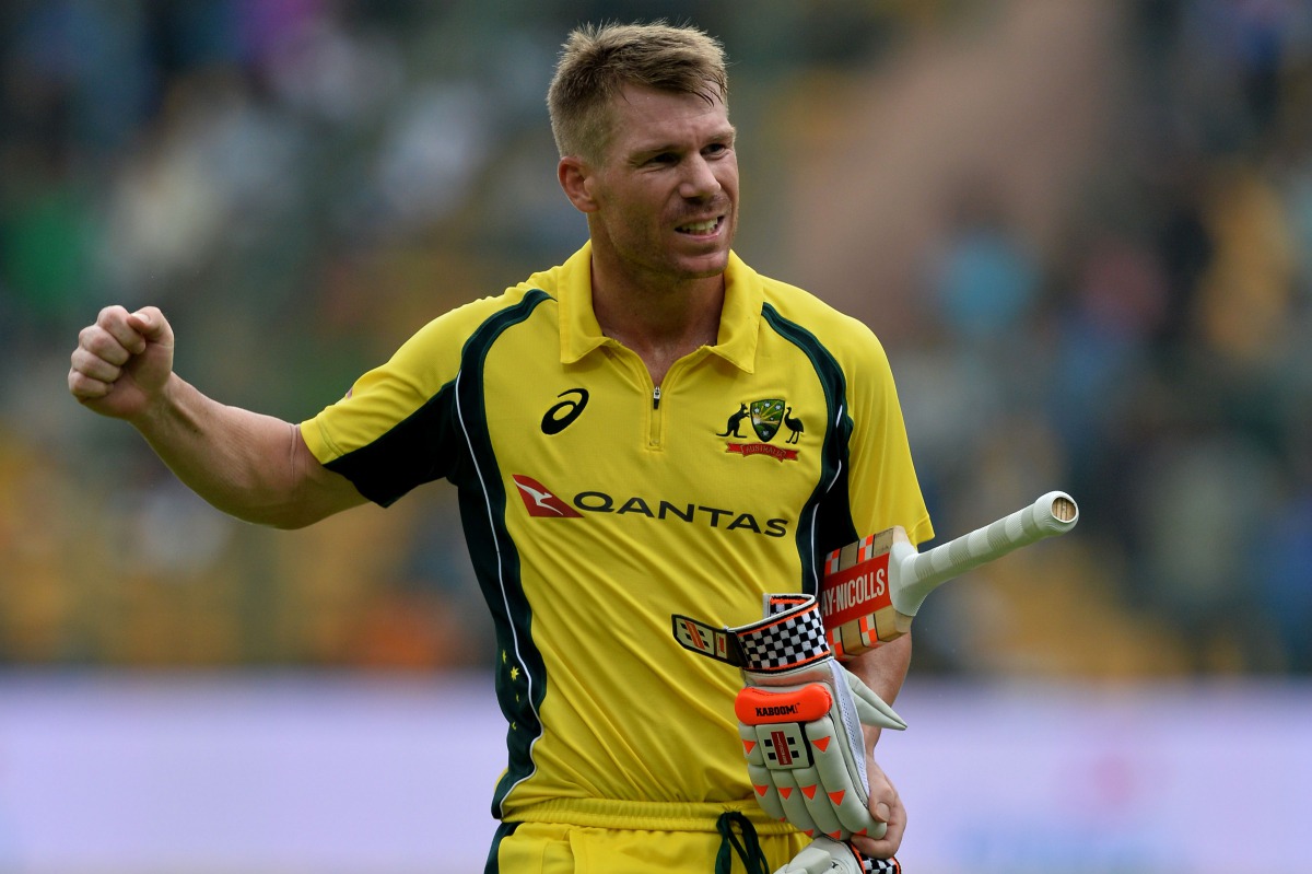 Australian batsman David Warner reacts while returning to the pavilion after being dismissed for 124 runs during the fourth one day international (ODI) match in the ongoing India-Australia cricket series at the M. Chinnaswamy Stadium in Bangalore on Septe