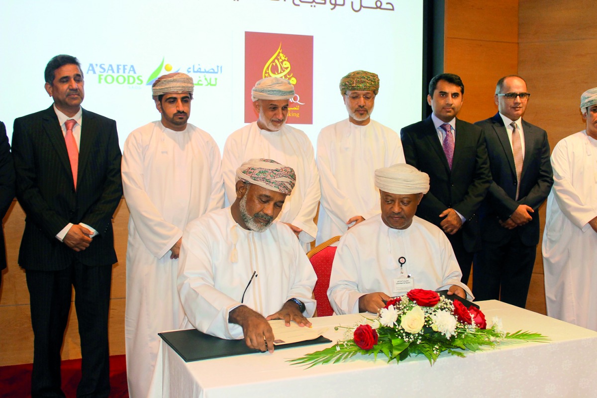 Officials of A’Saffa Foods and Bank Muscat ink financing deal to  expand the food company’s production capacities, at the bank’s heaquarters in Seeb. 