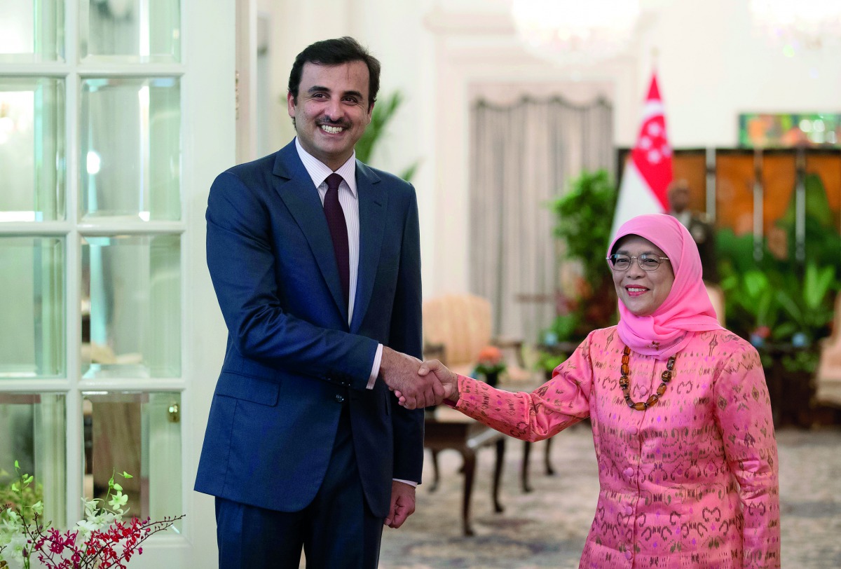 Emir H H Sheikh Tamim bin Hamad Al Thani is received by President of Singapore, Halimah Yacob, in Singapore, yesterday.
