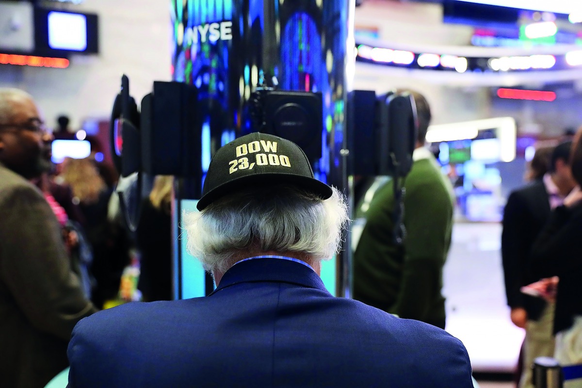 A trader wears a hat reading Dow 23,000 on the floor of the New York Stock Exchange (NYSE) on October 17, 2017 in New York City. The Dow Jones Industrial average briefly rose to 23,000 today before closing 2.56 below 23,000 at 22,997. Spencer Platt/Getty 