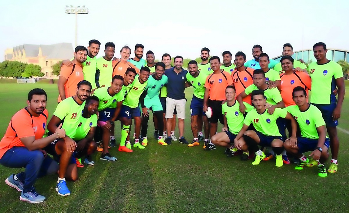 Delhi Dynamos players and officials pose for a picture with Barcelona and Spain legend Xavi during their training session at Aspire Academy in Doha on Thursday.
