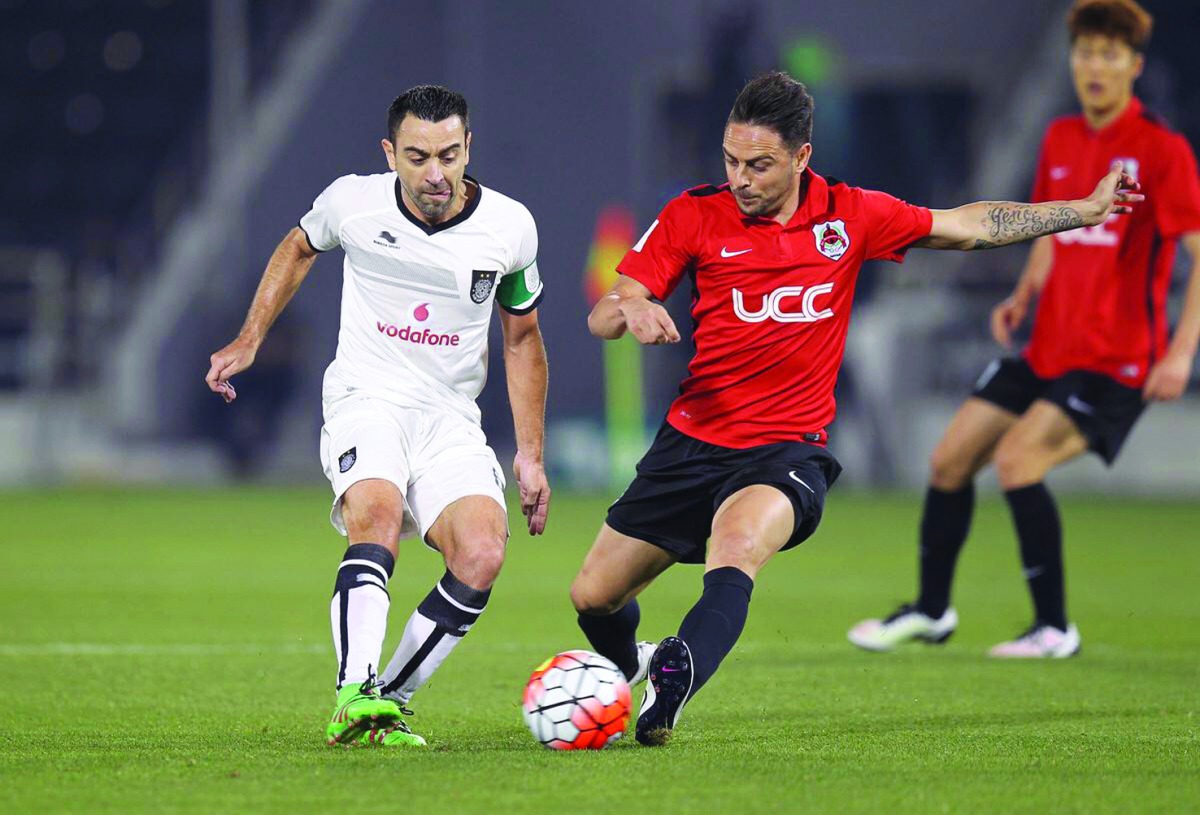 Al Sadd captain Xavi Hernandez (left) fights for the ball possession against Al Rayyan’s player during their ‘Qatari Clasico’ in this file picture.