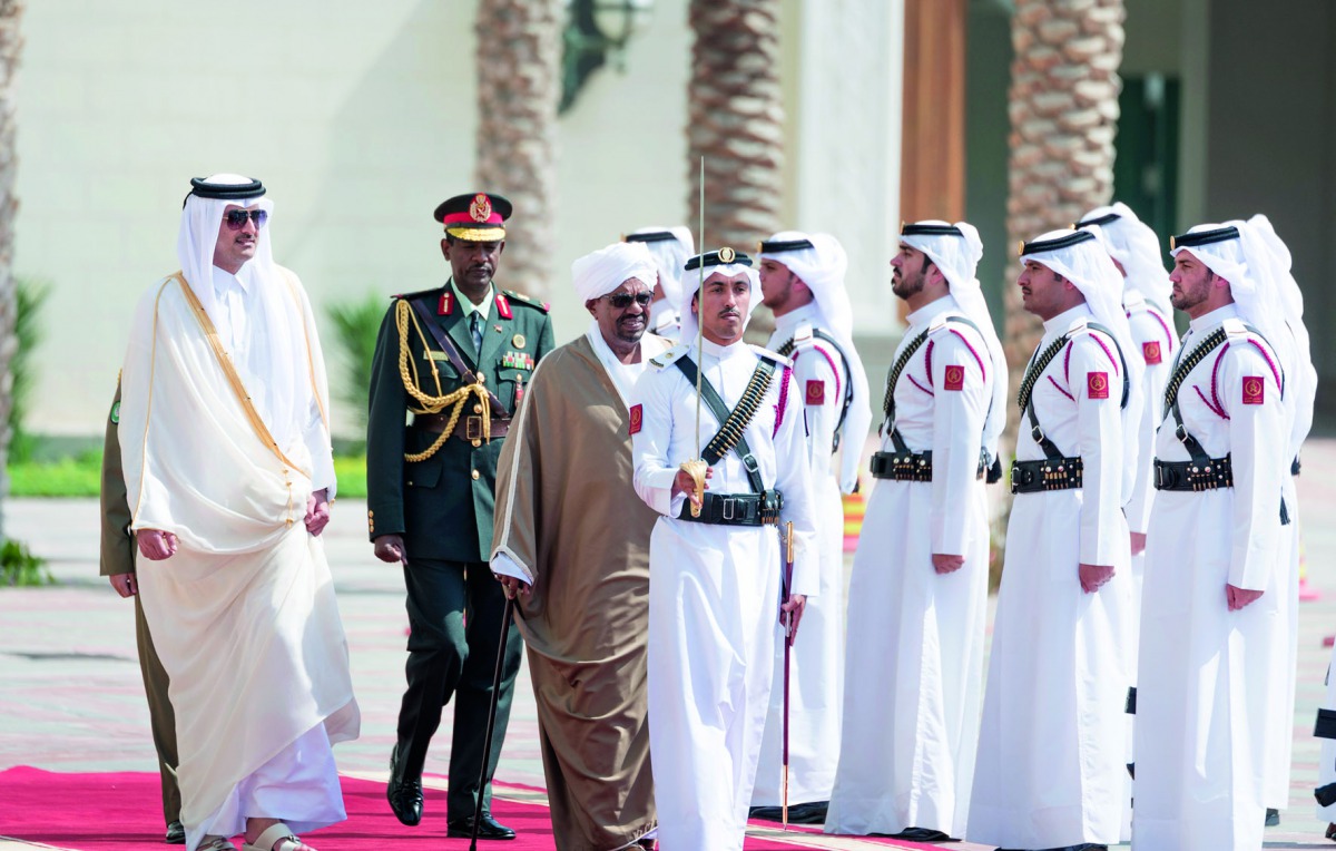 Emir H H Sheikh Tamim bin Hamad Al Thani with the President of the Republic of Sudan, Field Marshal Omar Hassan Al Bashir, during a reception at the Emiri Diwan, yesterday.