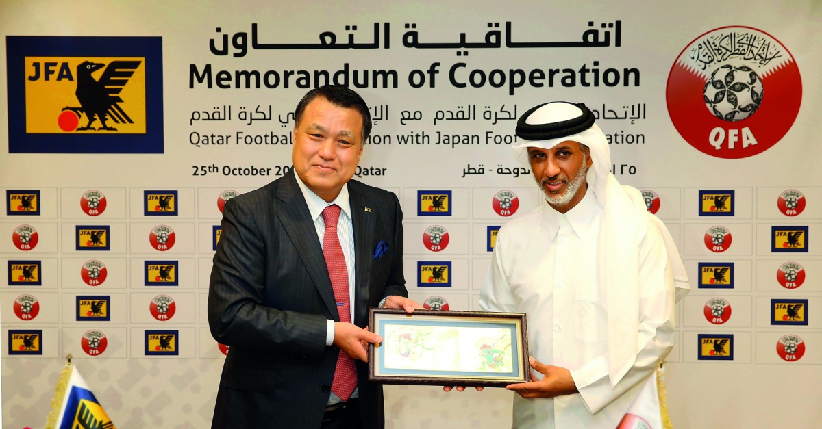 Qatar Football Association (QFA) President Sheikh Hamad bin Khalifa bin Ahmed Al Thani (right) and Japan Football Association (JFA) President Kohzo Tashima pose for a photograph during the cooperation agreement signing ceremony at Al Bidda Tower yesterday