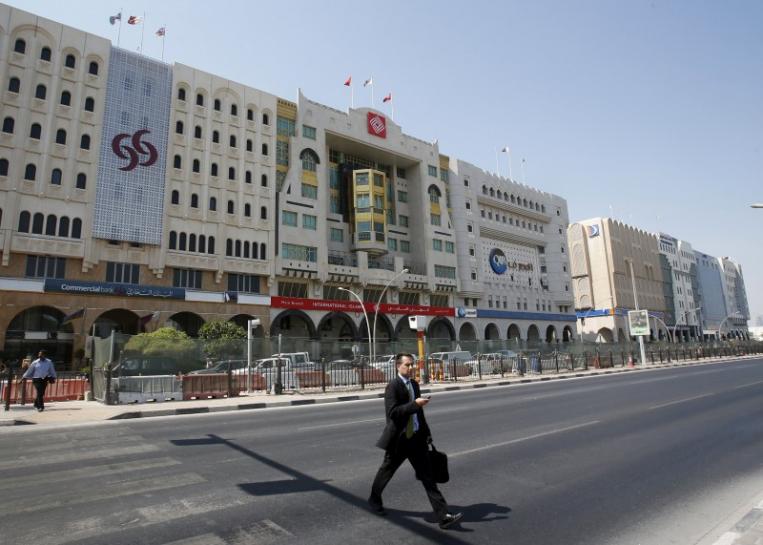 A man crosses Grand Hamad street where banks and financial institutions are located in Doha, Qatar.  (Reuters) 
